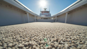Close-up view of textured fishing boat carpet installed on a boat deck, showing durable marine-grade fibers designed for traction and water drainage.